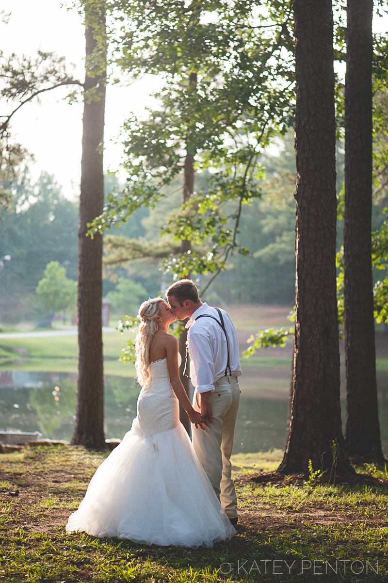 Newnan Utilities Cabin, wedding, tulle and lace, pink gingham bow tie, sunset, lake, kiss, husband and wife, bride and groom portrait